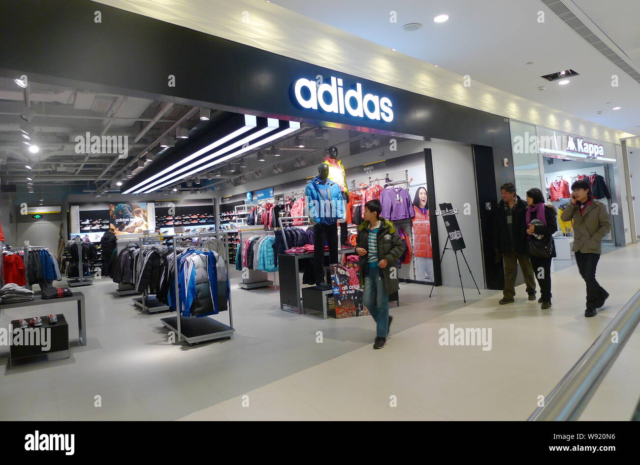 FILE--Customers walk past a sportswear store of Adidas at a shopping mall  in Tianjin, China, 13 January 2013. Adidas said lacklustre European dema  Stock Photo - Alamy