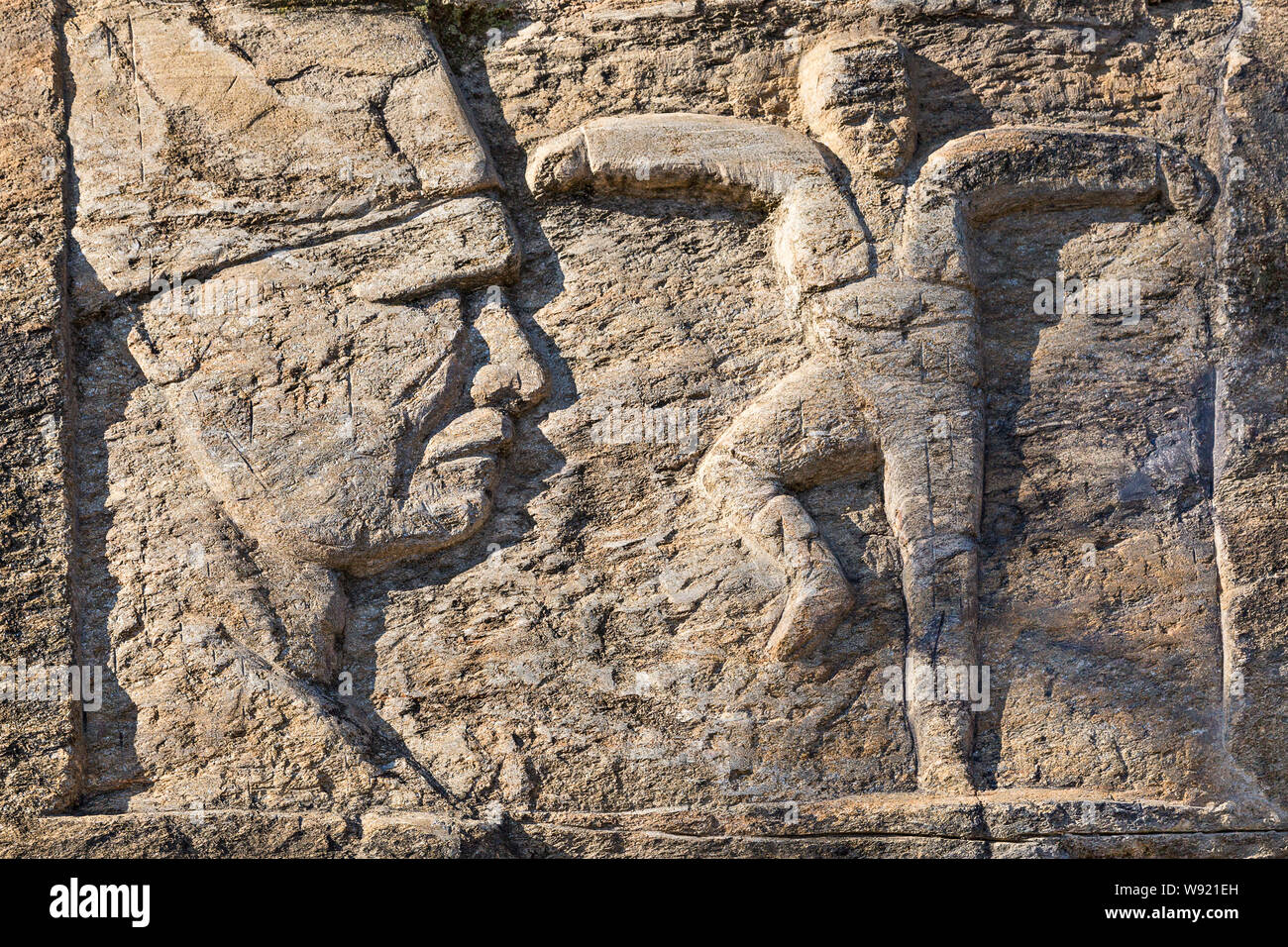 Sculpture over a rock wall representing Ataturk and a person performing local folk dance of Zeybek, in Birgi, Turkey. Stock Photo
