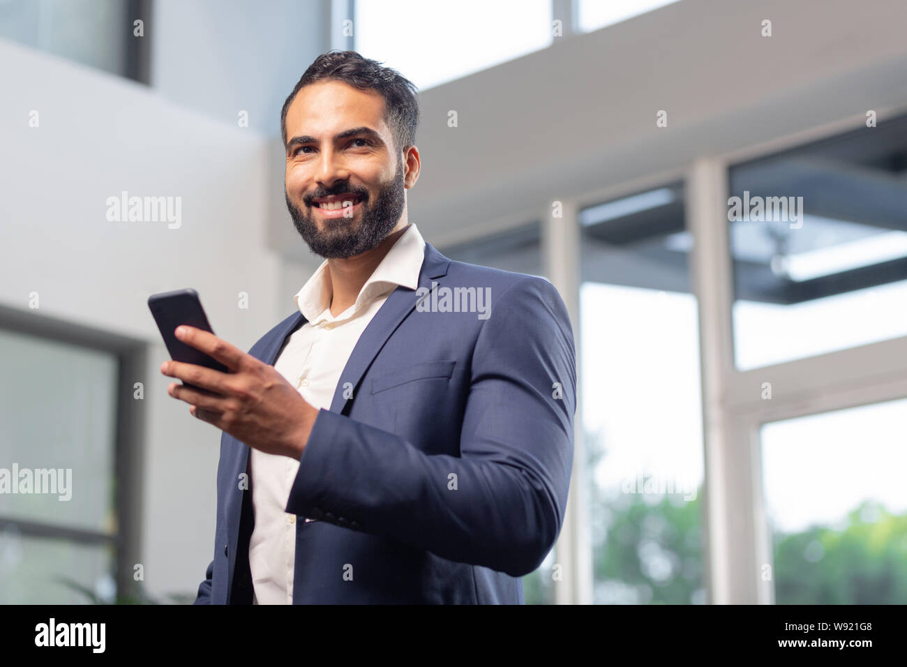 Portrait of handsome man that holding his telephone Stock Photo
