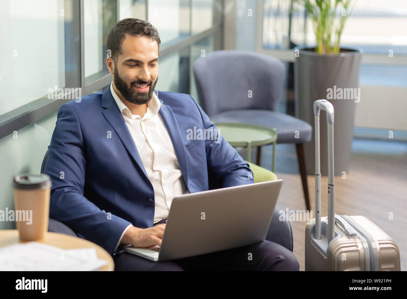 Positive delighted business owner being in business trip Stock Photo