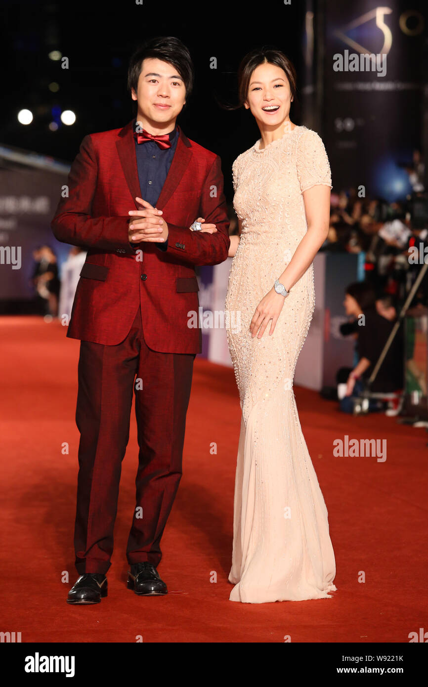 Chinese pianist Lang Lang, left, and Hong Kong singer Denise Ho pose on the red carpet as they arrive at the 50th Golden Horse Awards ceremony in Taip Stock Photo