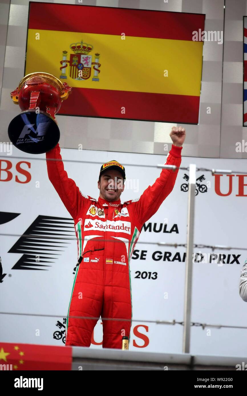 Spanish F1 Driver Fernando Alonso Of Ferrari Celebrates With His Champion Trophy After Winning The 2013 Formula One Chinese Grand Prix At The Shanghai Stock Photo Alamy