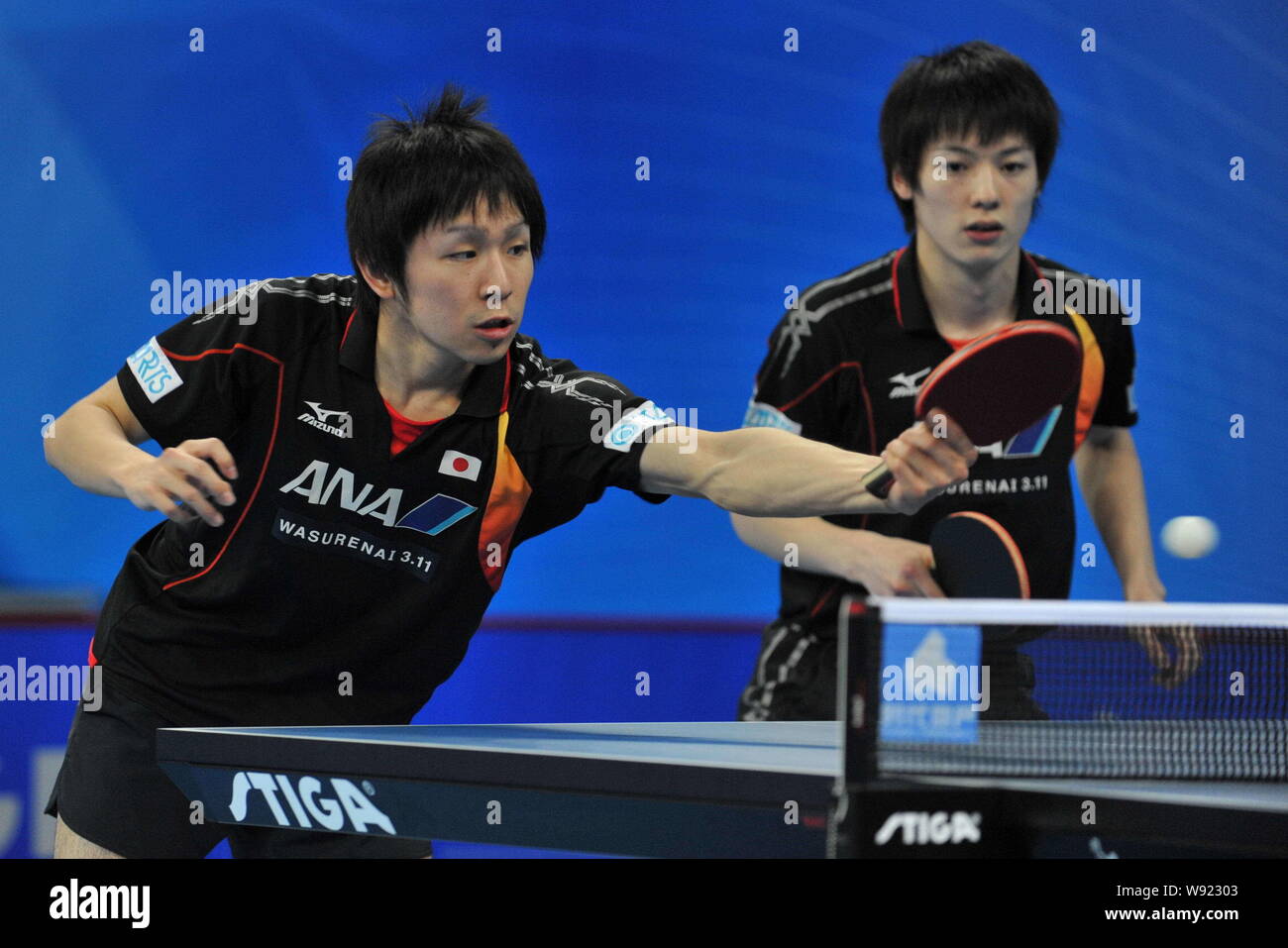 Koki Niwa, left, and Kenta Matsudaira of Japan compete against their Australian counterparts in their mens doubles event during the first round of the Stock Photo