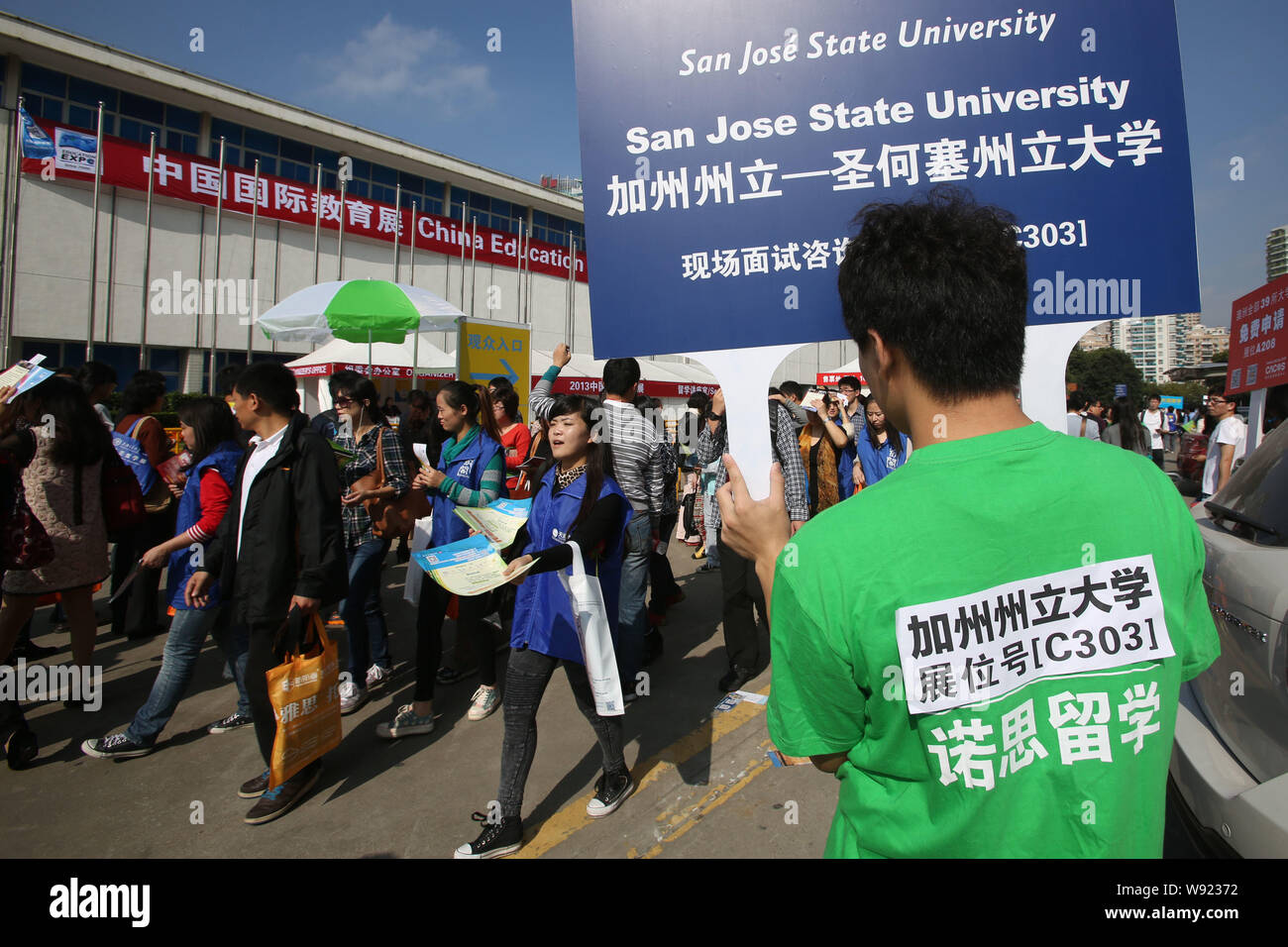 A Chinese Employee Holds Up A Signboard Of San Jose State