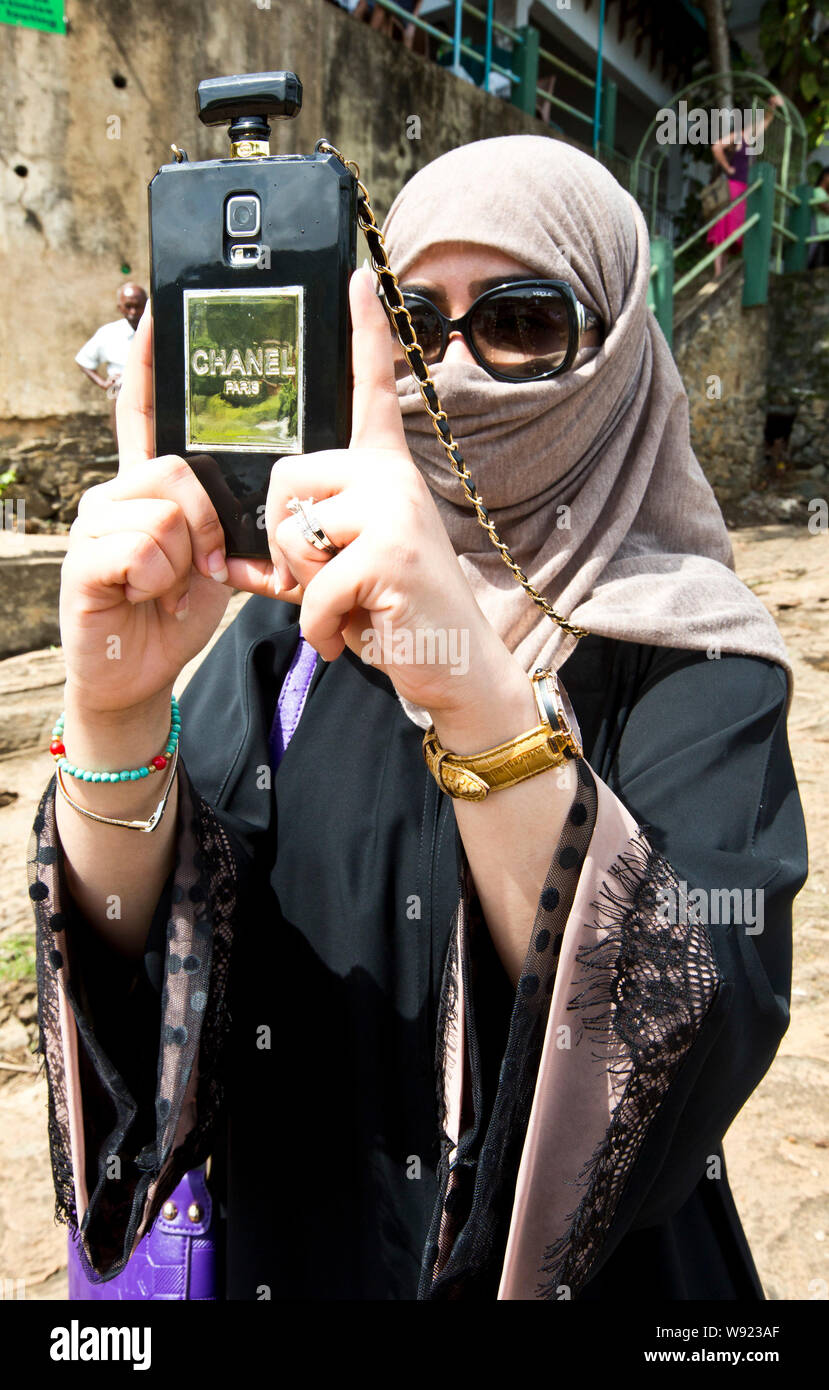 WOMAN WEARING A NIQAB VEIL AND A SMARTPHONE IN SRI LANKA Stock Photo