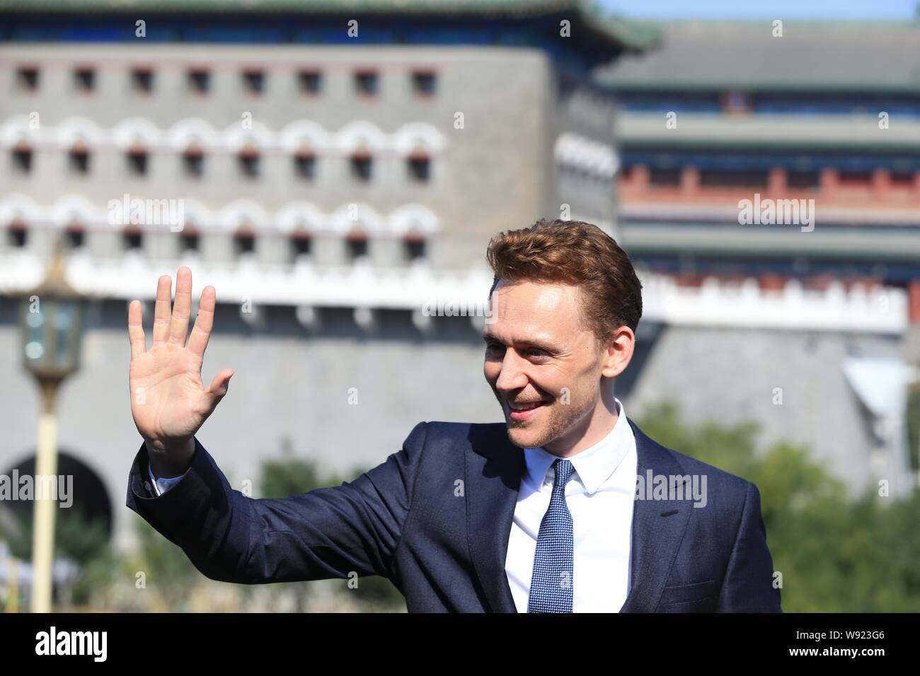 English actor Tom Hiddleston waves during a photocall to promote his new movie, Thor: The Dark World, in front of Zhengyang Gate in Beijing, China, 11 Stock Photo