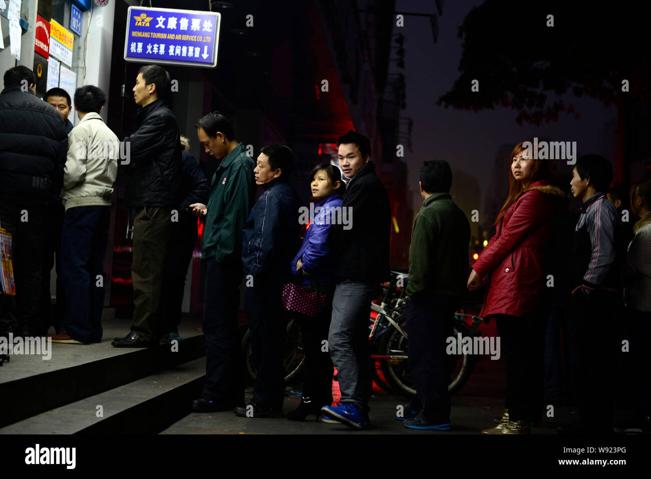 --FILE--Migrant workers queue up to buy train tickets in group over night at a ticket sales point in Dongguan city, southeast Chinas Guangdong provinc Stock Photo