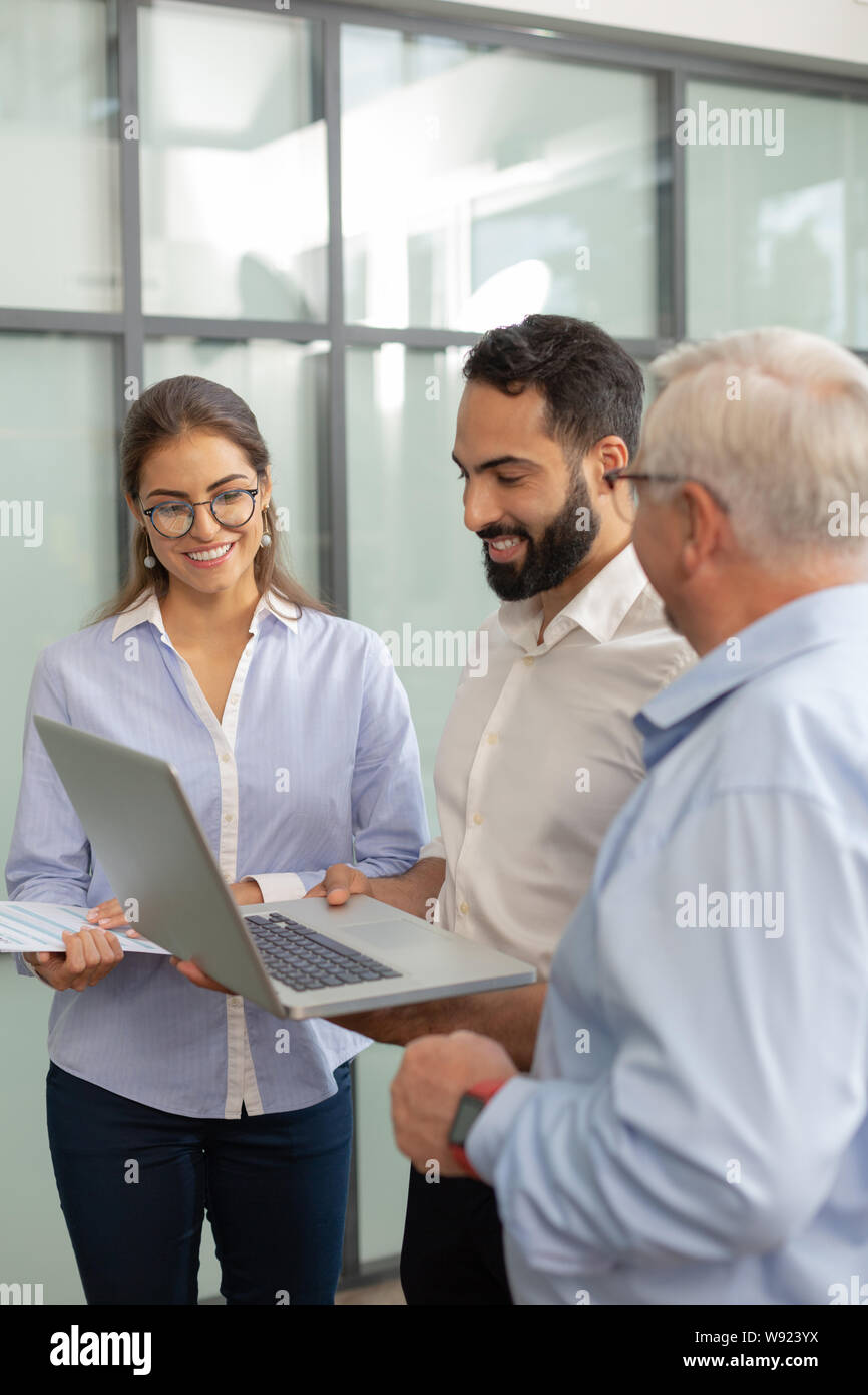 Handsome brunette young man demonstrating his project Stock Photo - Alamy