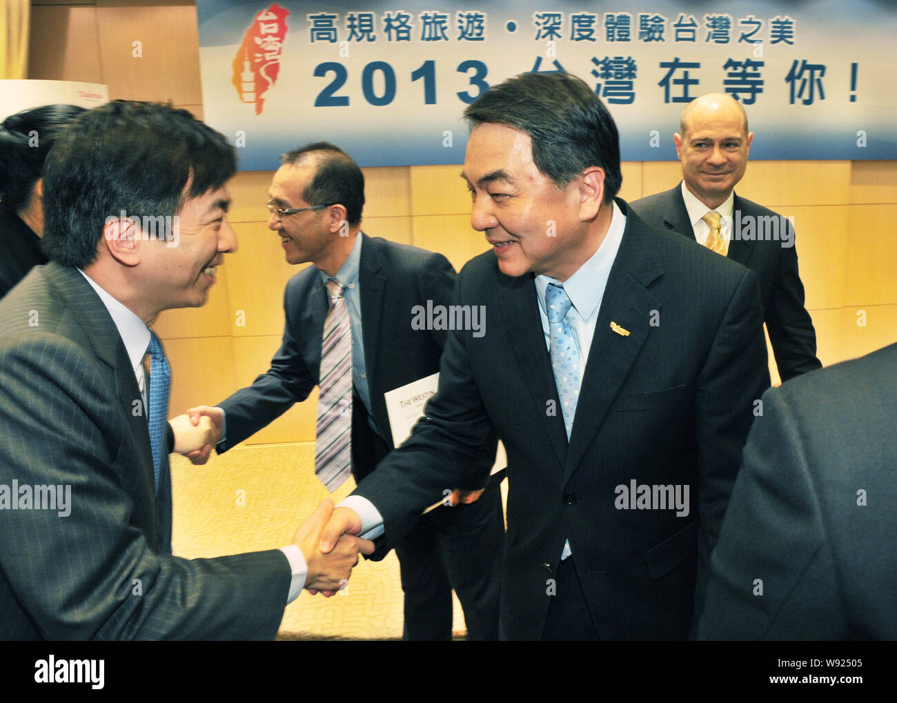 Taiwan officials shake hands with heads of travel agencies during the press conference for the cooperation of receiving Chinese Amway employees visit Stock Photo