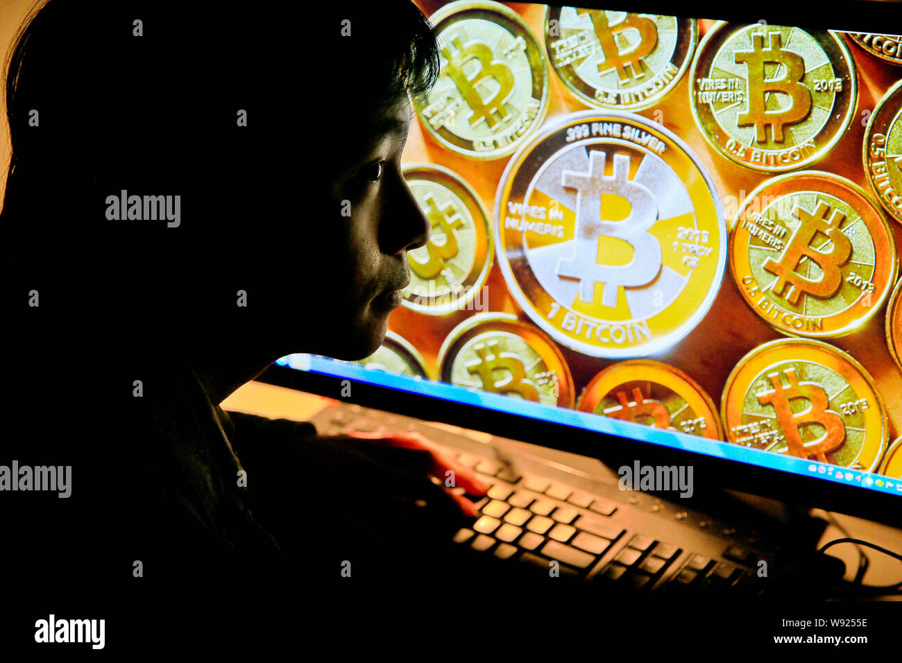 A Chinese netizen browses a photo of Bitcoins on his desktop computer in Guangzhou city, south Chinas Guangdong province, 9 December 2013.   Some vend Stock Photo