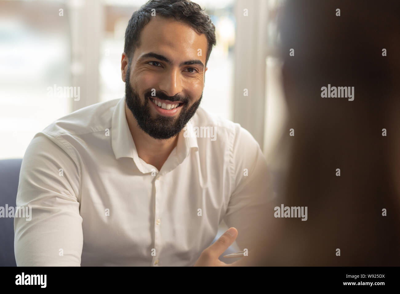 Handsome brunette male person looking at his partner Stock Photo