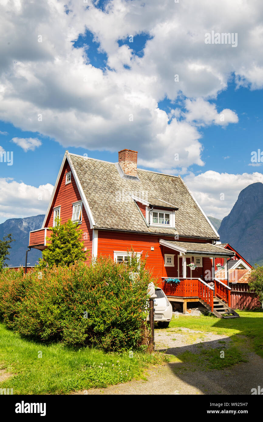 Beautiful traditional red wooden house in Aurlandsvangen at the coast of Aurlandsfjord, branche of Sognefjord in Norway Stock Photo