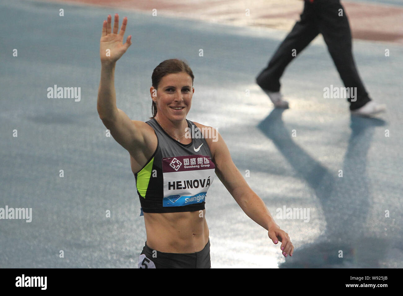 Zuzana Hejnova of The Czech Republic waves to the spectators after winning the womens 400m hurdles event at the 2013 IAAF Diamond League in Shanghai, Stock Photo