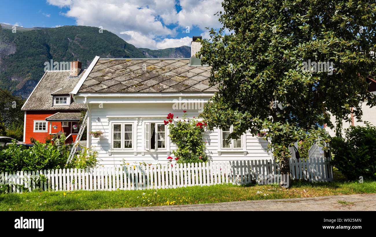 Beautiful traditional white and red wooden house in Aurlandsvangen at the coast of Aurlandsfjord, branche of Sognefjord in Norway Stock Photo