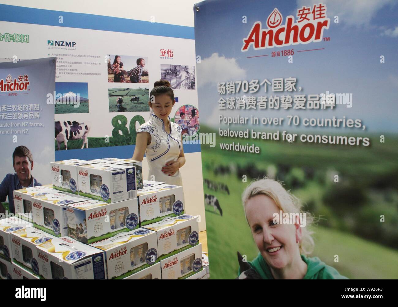 FILEAn employee looks at cartons of Anchor milk of Fonterra