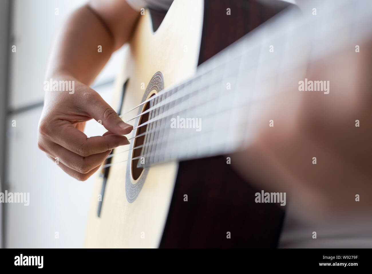 Woman hands playing acoustic classic guitar the musician of jazz and easy listening style select focus shallow depth of field Stock Photo