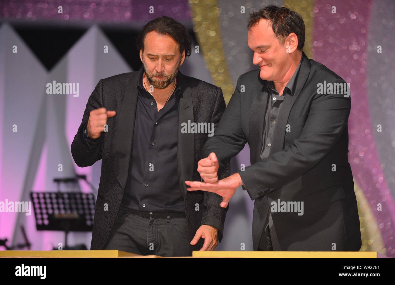 U.S. actor Nicolas Cage, left, and director Quentin Tarantino make their  handprints at a reception party for the 10th Huading Awards in Macau, China  Stock Photo - Alamy