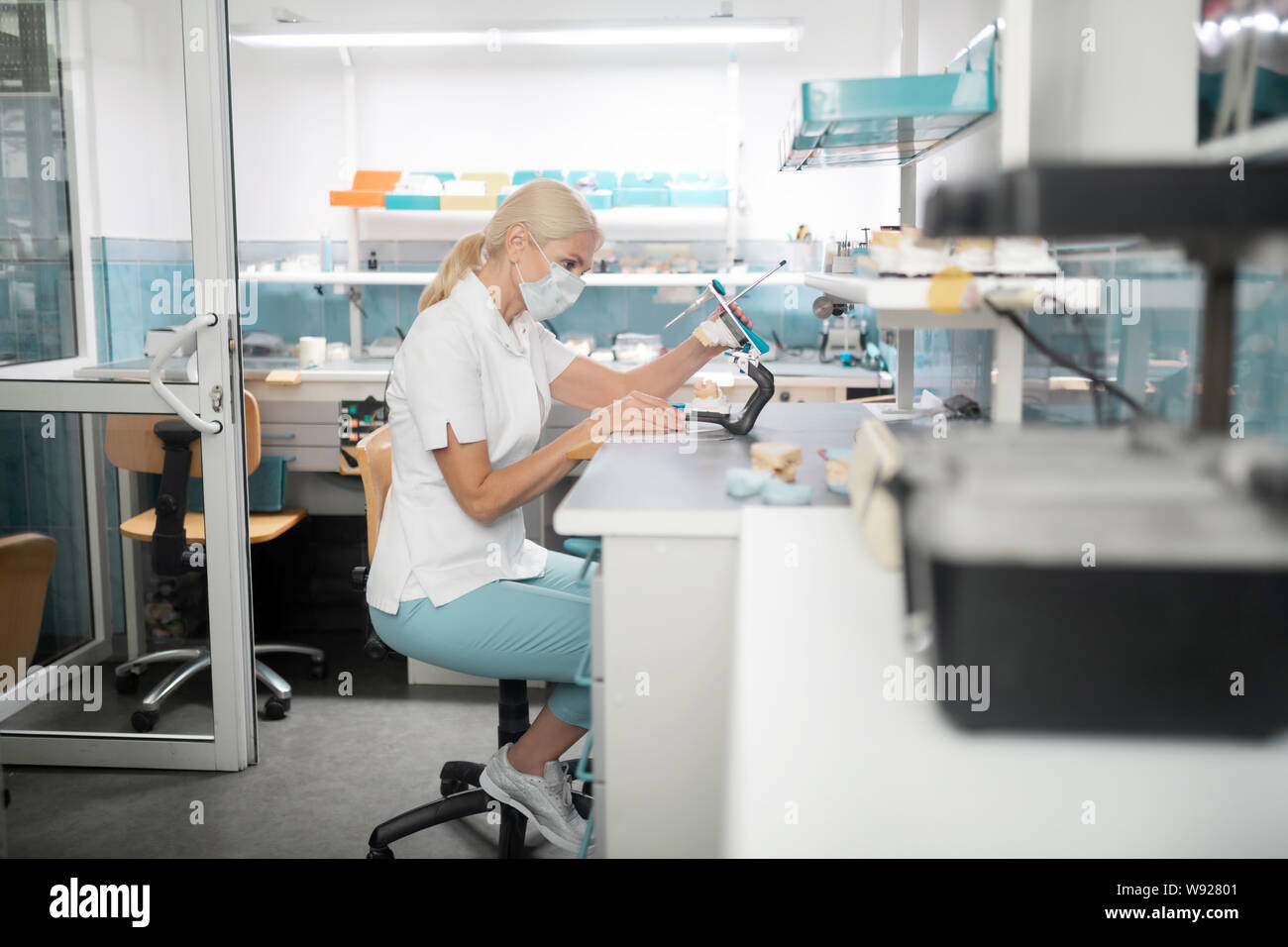 Dental technician working on cast model of teeth Stock Photo - Alamy