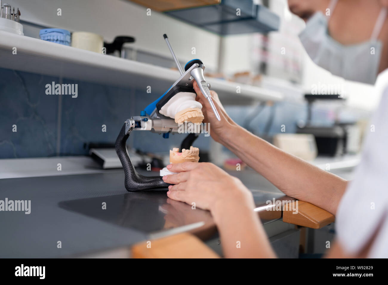 Professional dental prosthetic technician creating new prosthesis Stock