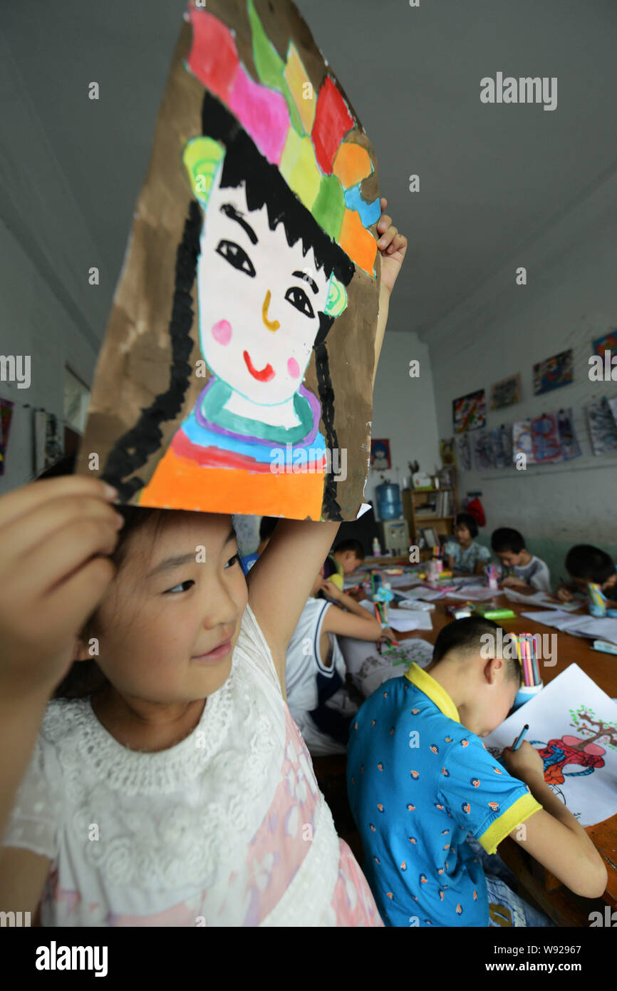 Young Chinese schoolchildren learn drawing at a school during their summer vacation in Zouping county, Binzhou city, east Chinas Shandong province, 10 Stock Photo