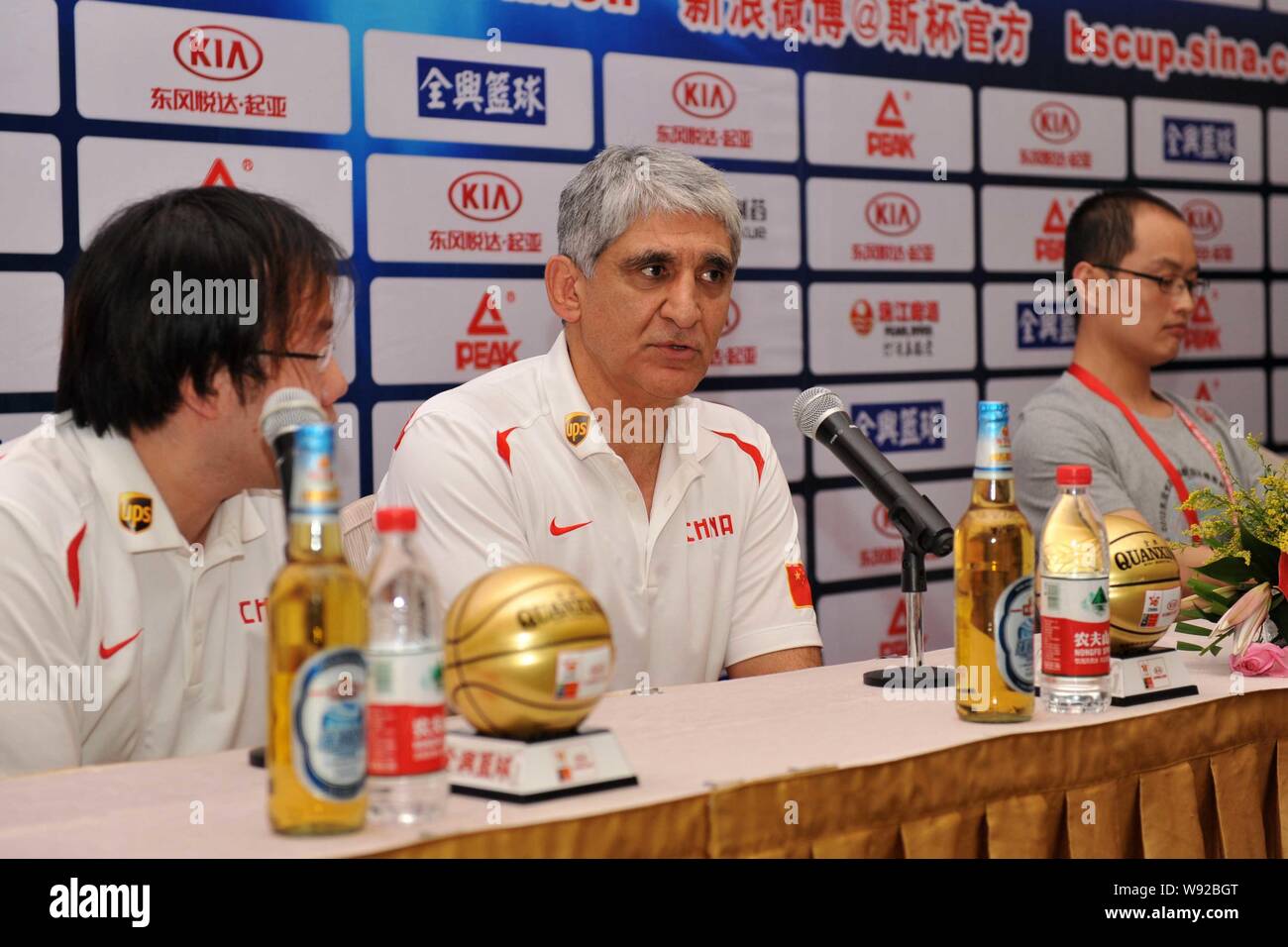 Panagiotis Giannakis, center, the new head coach of the China mens basketball team, attends a press conference for the Stankovic Continental Cup 2013 Stock Photo