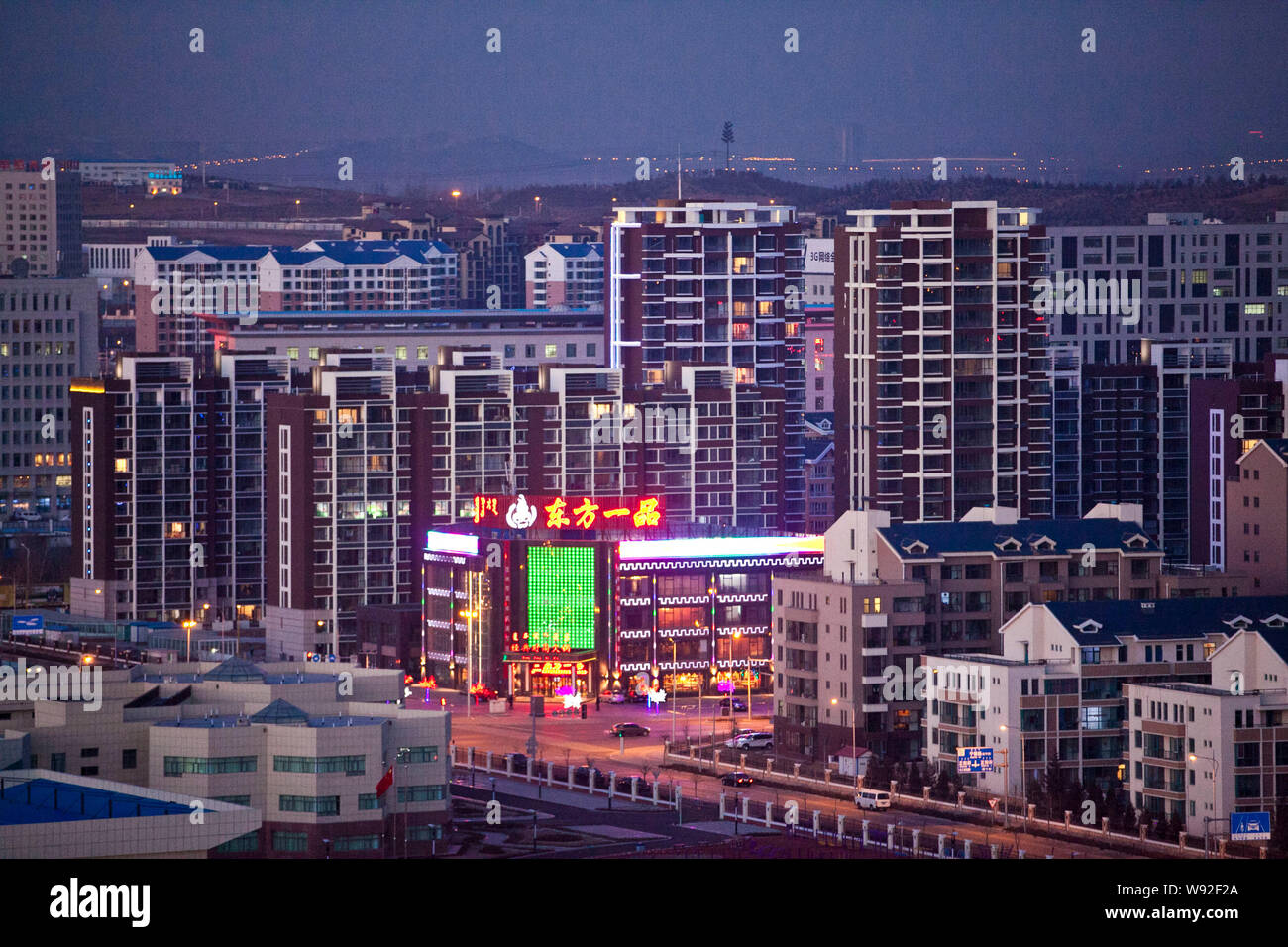--FILE--Cars pass by new residential apartment buildings along a nearly ...