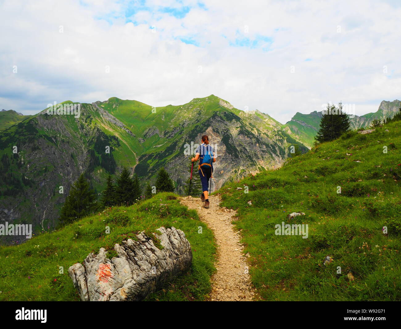Girl hiking in the mountains of the Allgäu Stock Photo - Alamy