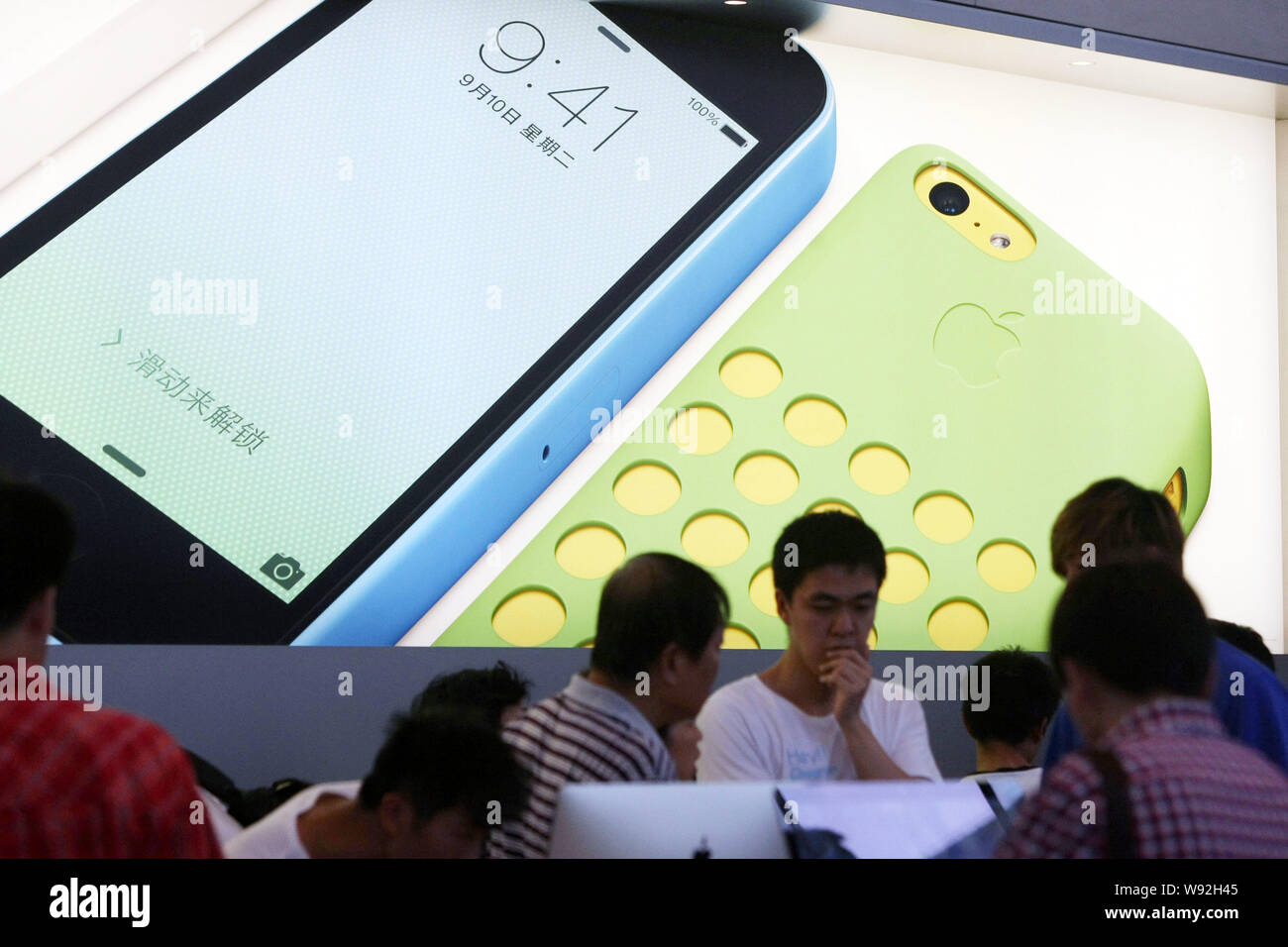An advertisement for new iPhone 5c smartphones of Apple is seen at an Apple store in Shanghai, China, 20 September 2013.   Apple Inc. (AAPL) attracted Stock Photo