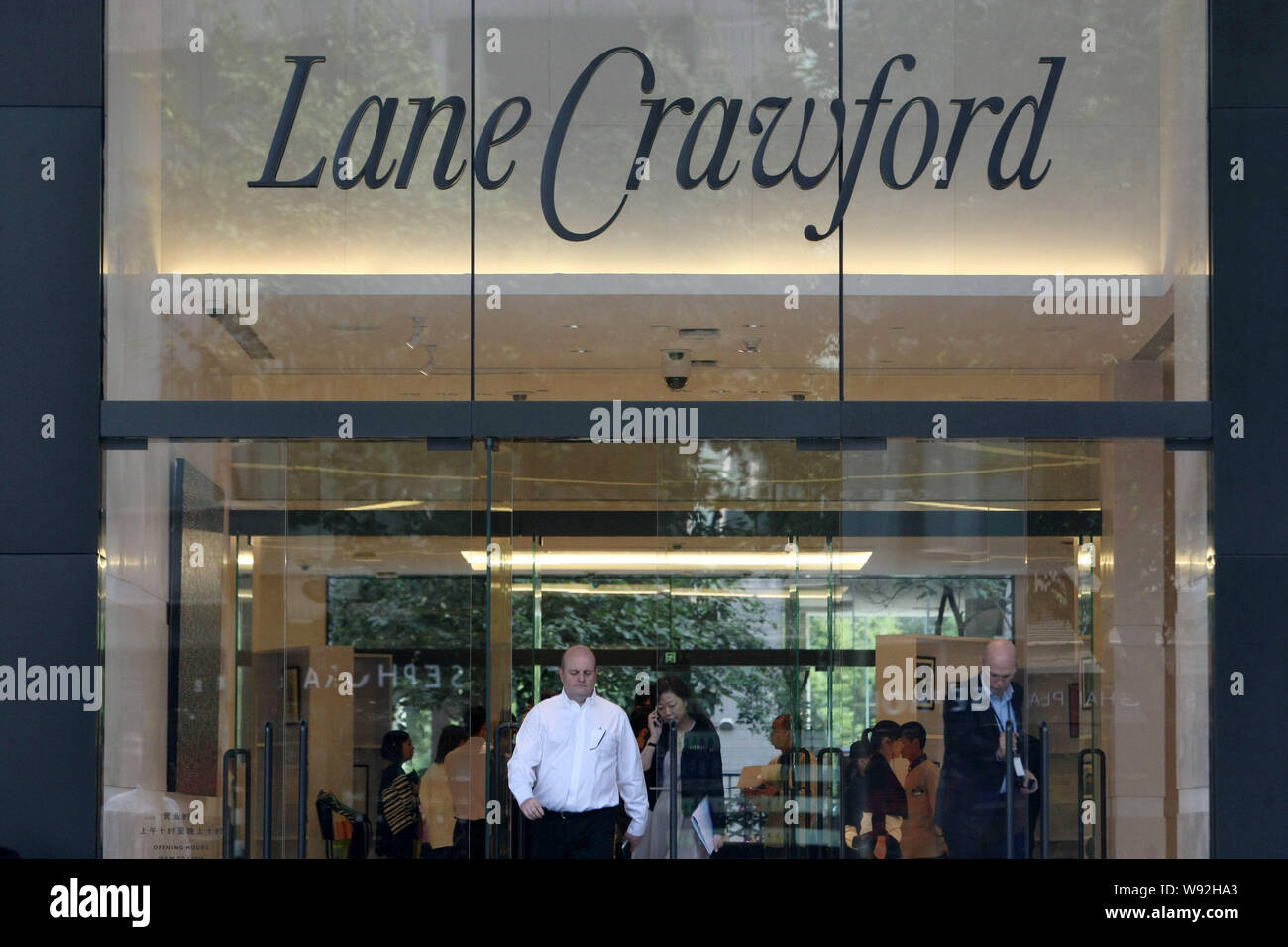 --FILE--Customers exit the flagship store of Lane Crawford in Shanghai, China, 10 October 2013.   Few luxury brands have been in Asia as long as Lane Stock Photo