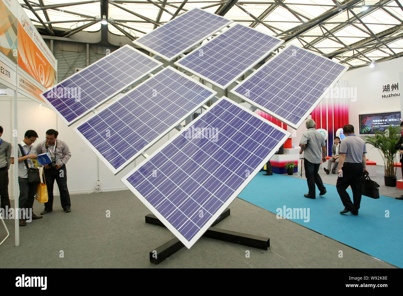 FILEVisitors look at solar panels on display during an exhibition