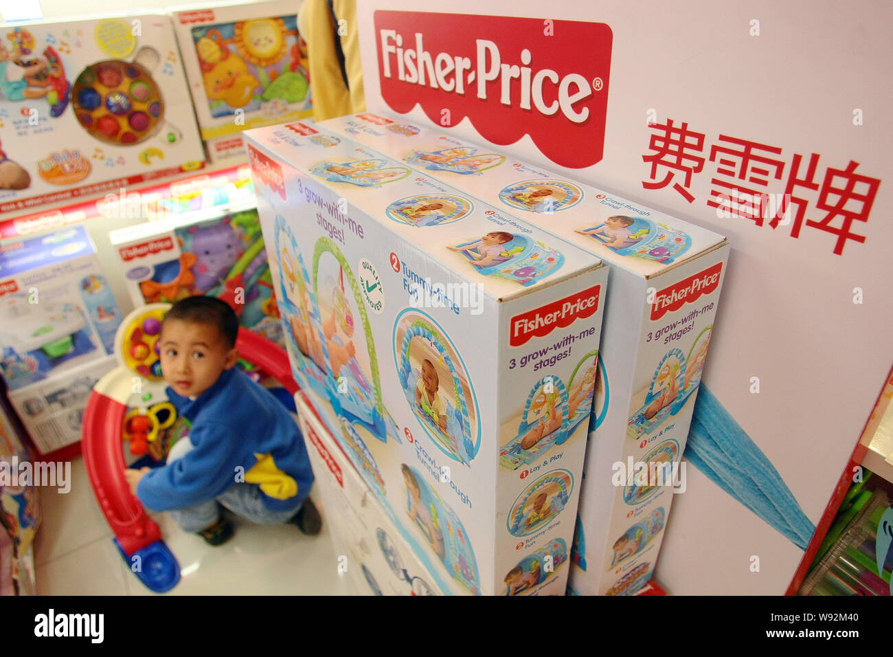 FILE--A young boy plays with Fisher-Price toys of Mattel at a store in Shanghai, China, 9 November 2011. Mattel Inc. said it is looking into alleg Stock Photo - Alamy