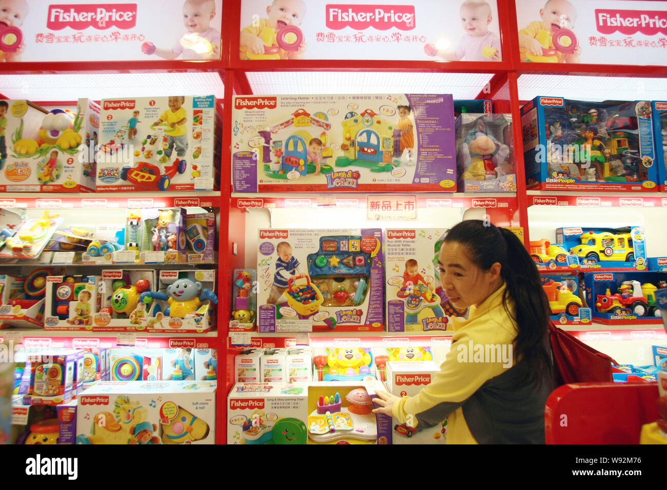--FILE--A customer shops for Fisher-Price toys of Mattel at a store in Shanghai, China, 9 November 2011.   Mattel Inc. said it is looking into allegat Stock Photo
