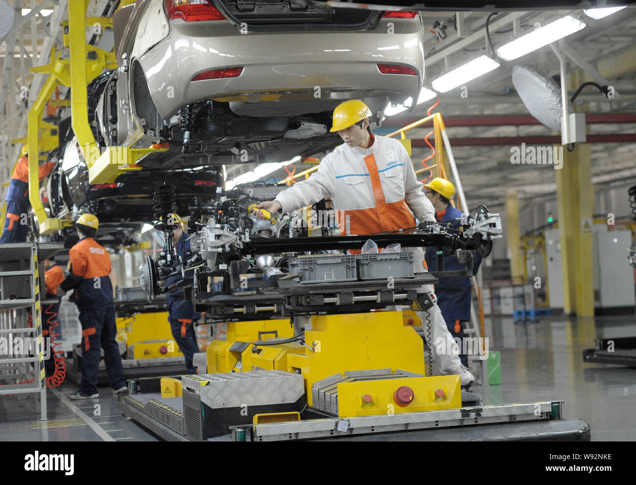 Chinese workers assemble Emgrand cars on the assembly line at an auto ...
