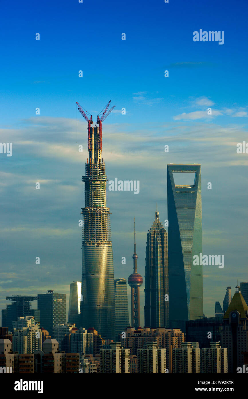 The construction of the structure of the Shanghai Tower, left, is ...