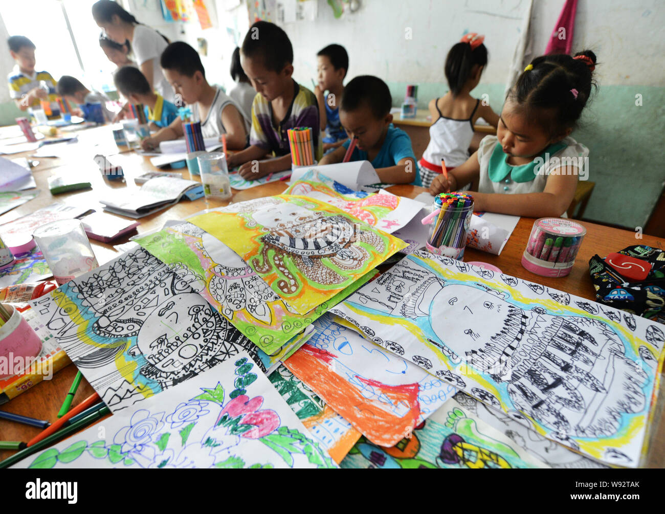 Young Chinese schoolchildren learn drawing at a school during their summer vacation in Zouping county, Binzhou city, east Chinas Shandong province, 10 Stock Photo