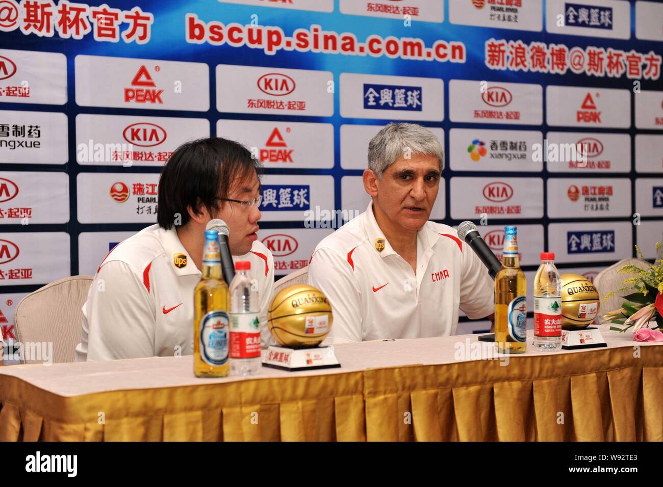 Panagiotis Giannakis, right, the new head coach of the China mens basketball team, attends a press conference for the Stankovic Continental Cup 2013 i Stock Photo