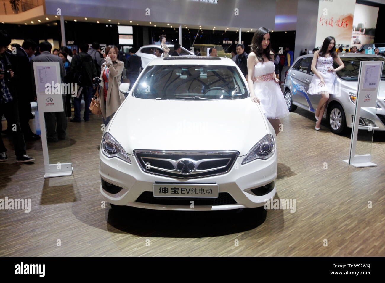 FILE--A model poses with a Shenbao electric car of BAIC Motor during ...
