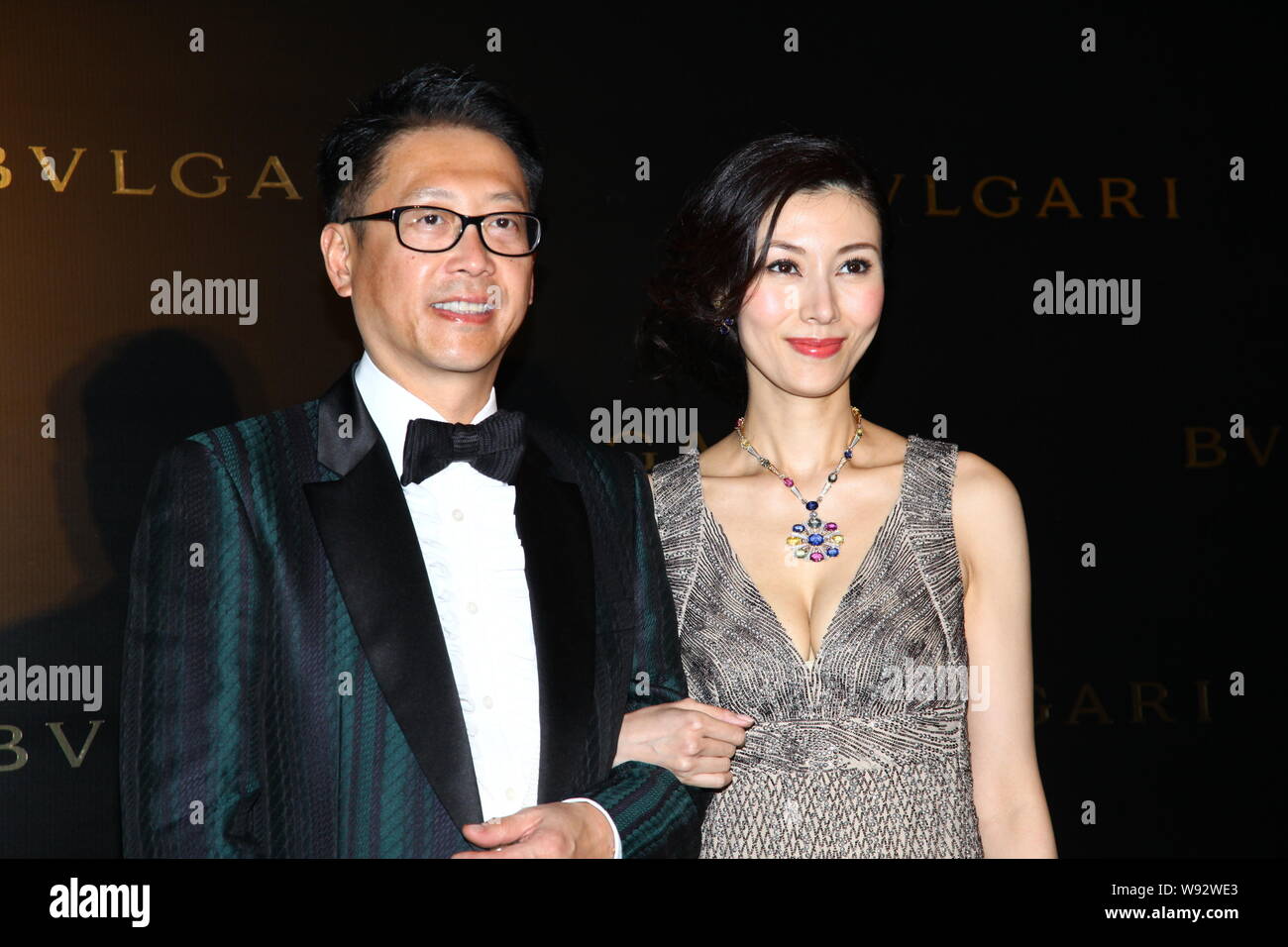 Hong Kong actress Michelle Lee, right, and her husband Julian Hsu pose as  they arrive for a party for the re-opening and 10th anniversary of the  Bulga Stock Photo - Alamy