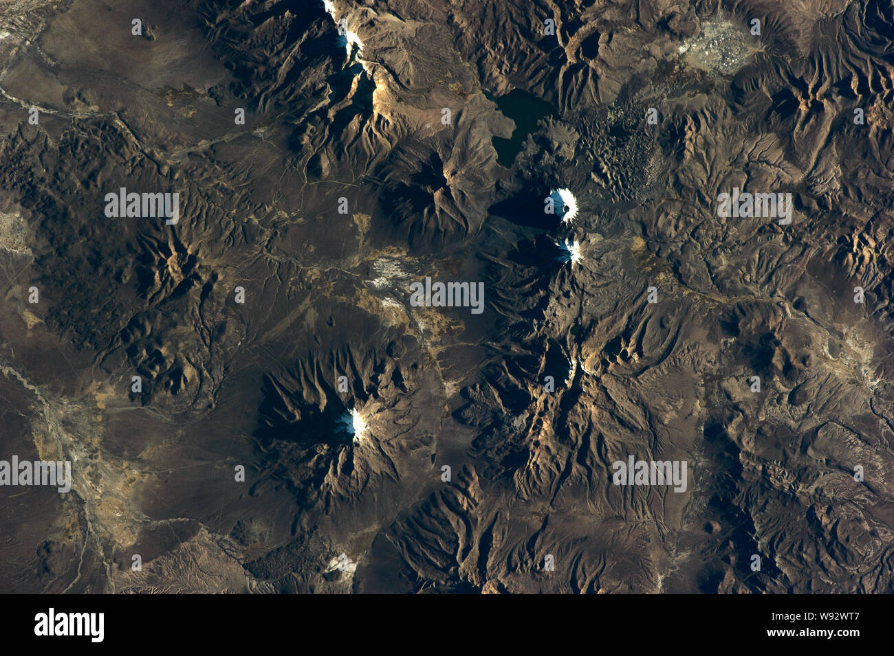 Chilean volcanos mountains relief Satellite view texture from earth above . Elements of this image furnished by NASA. Stock Photo