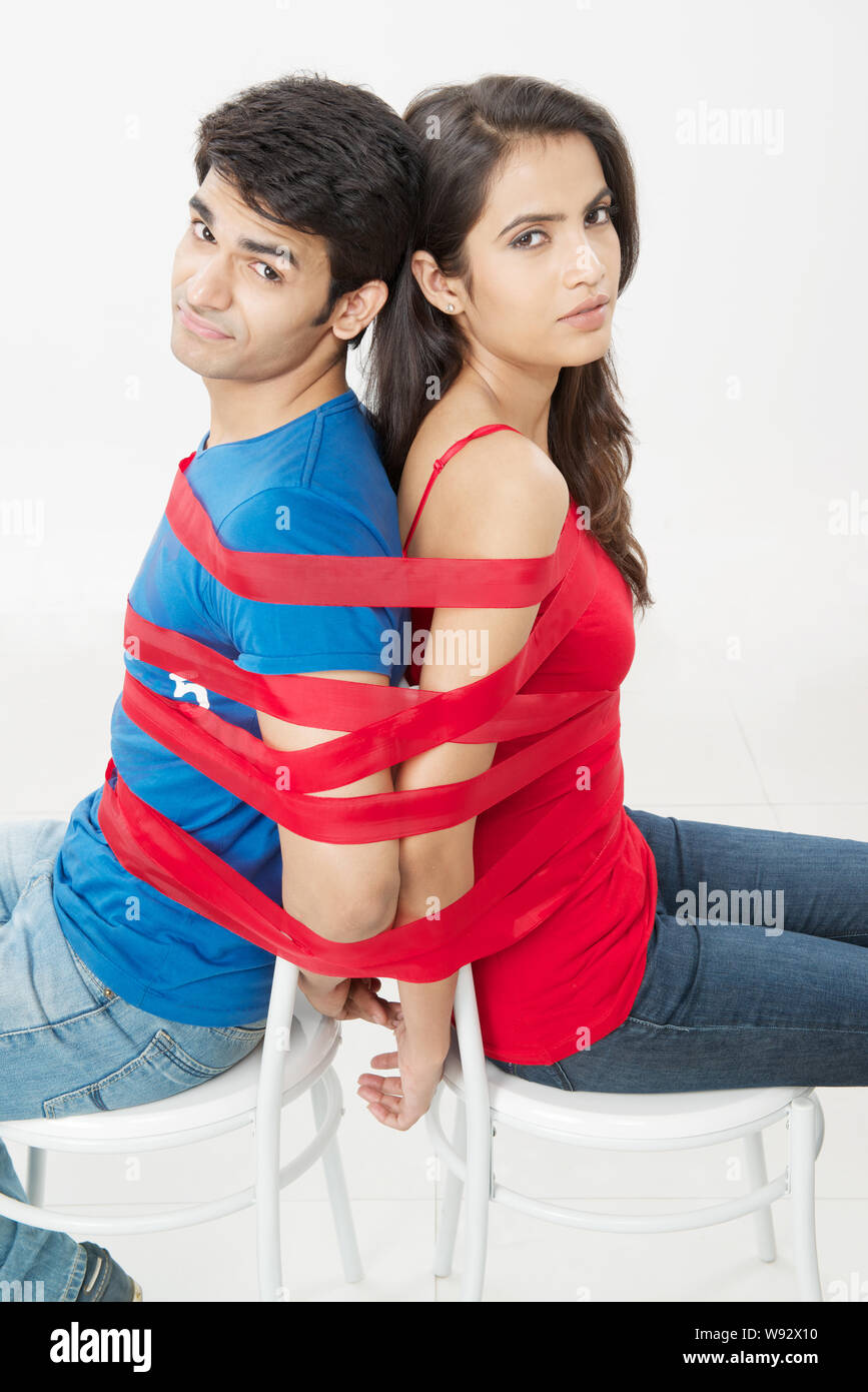 Young couple tied up with ribbon Stock Photo