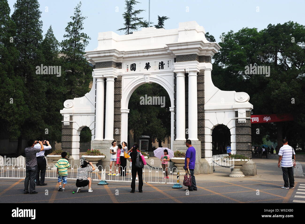 --FILE--People take photos at the symbolic Second Gate of Tsinghua University in Beijing, China, 23 August 2011.   Chinas Tsinghua University, reveale Stock Photo