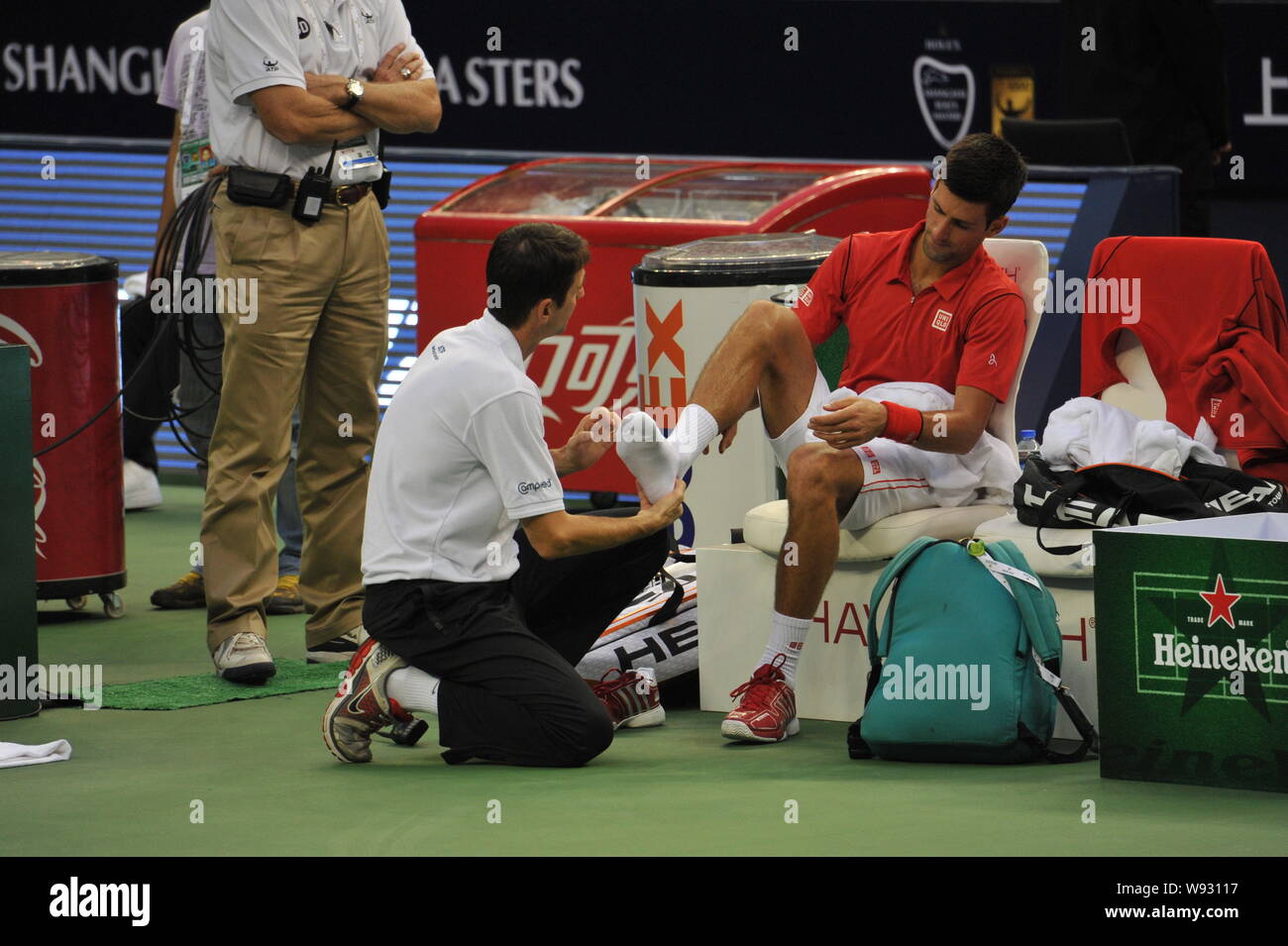 Serbias Novak Djokovic receives medical attention on his foot during a match against Spains Marcel Granollers for the Shanghai Masters tennis tourname Stock Photo
