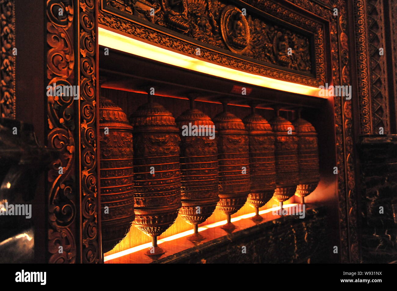 A line of prayer wheels with elaborate carvings on them is seen in Wu Yin Tan Cheng in Wuxi city, east Chinas Jiangsu province, 3 August 2013.   Locat Stock Photo