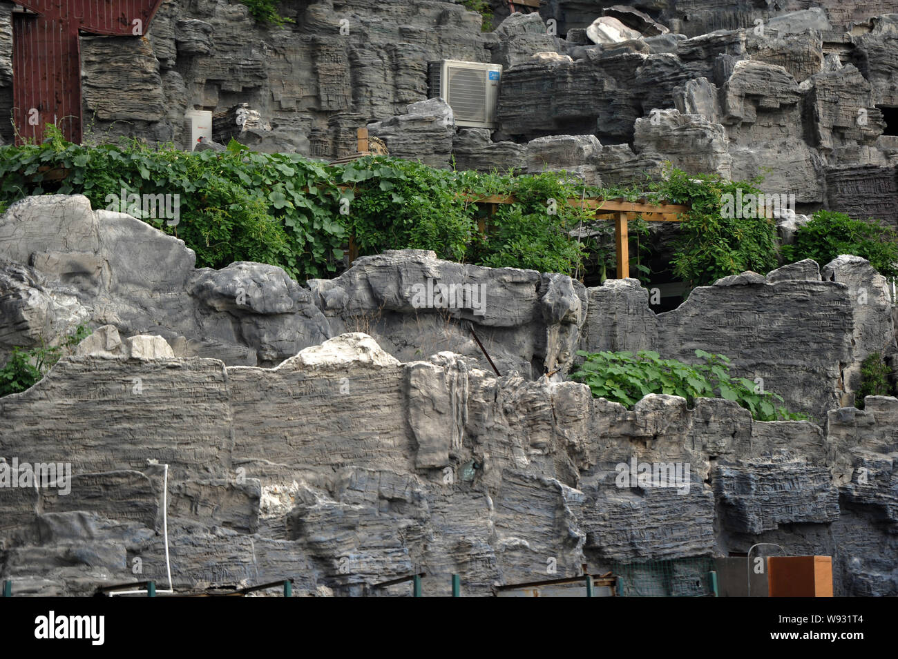A rooftop villa complete with rocks and flora is seen on top of a high ...