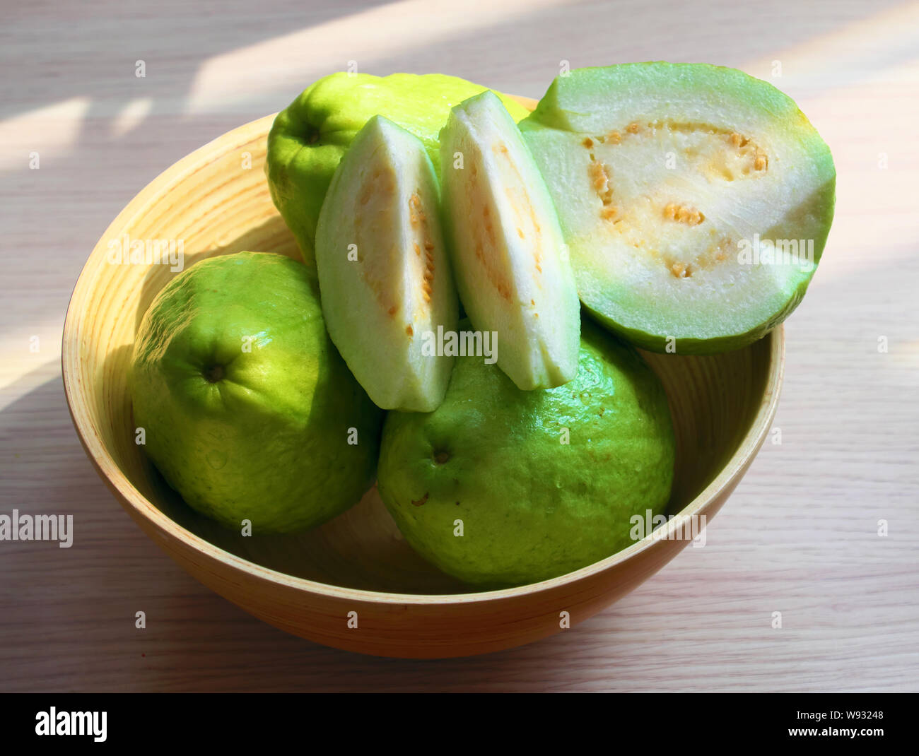 Close up group of guava fruit with sliced on white wooden background