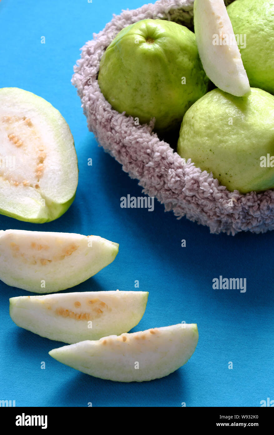 Close up group of guava fruit with sliced on blue background, tropical