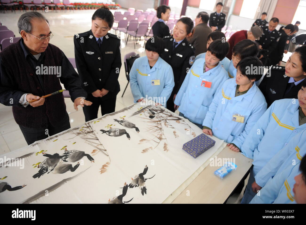 --FILE--An artist teaches Chinese inmates to draw a Chinese painting at a female labor camp in Beijing, China, 9 December 2010.   Chinas top legislatu Stock Photo