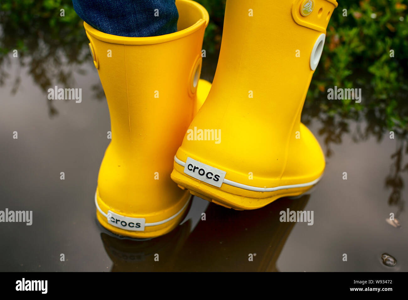 Tambov, Russian Federation - August 08, 2019 Women legs in yellow Crocs  boots in the puddle Stock Photo - Alamy