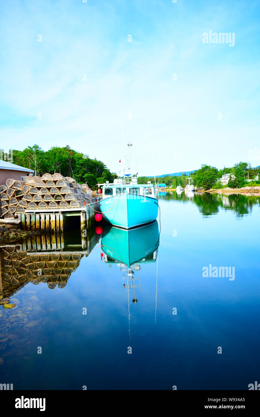 Fishing boat and lobster traps in a harbor on Cape Breton. Stock Photo
