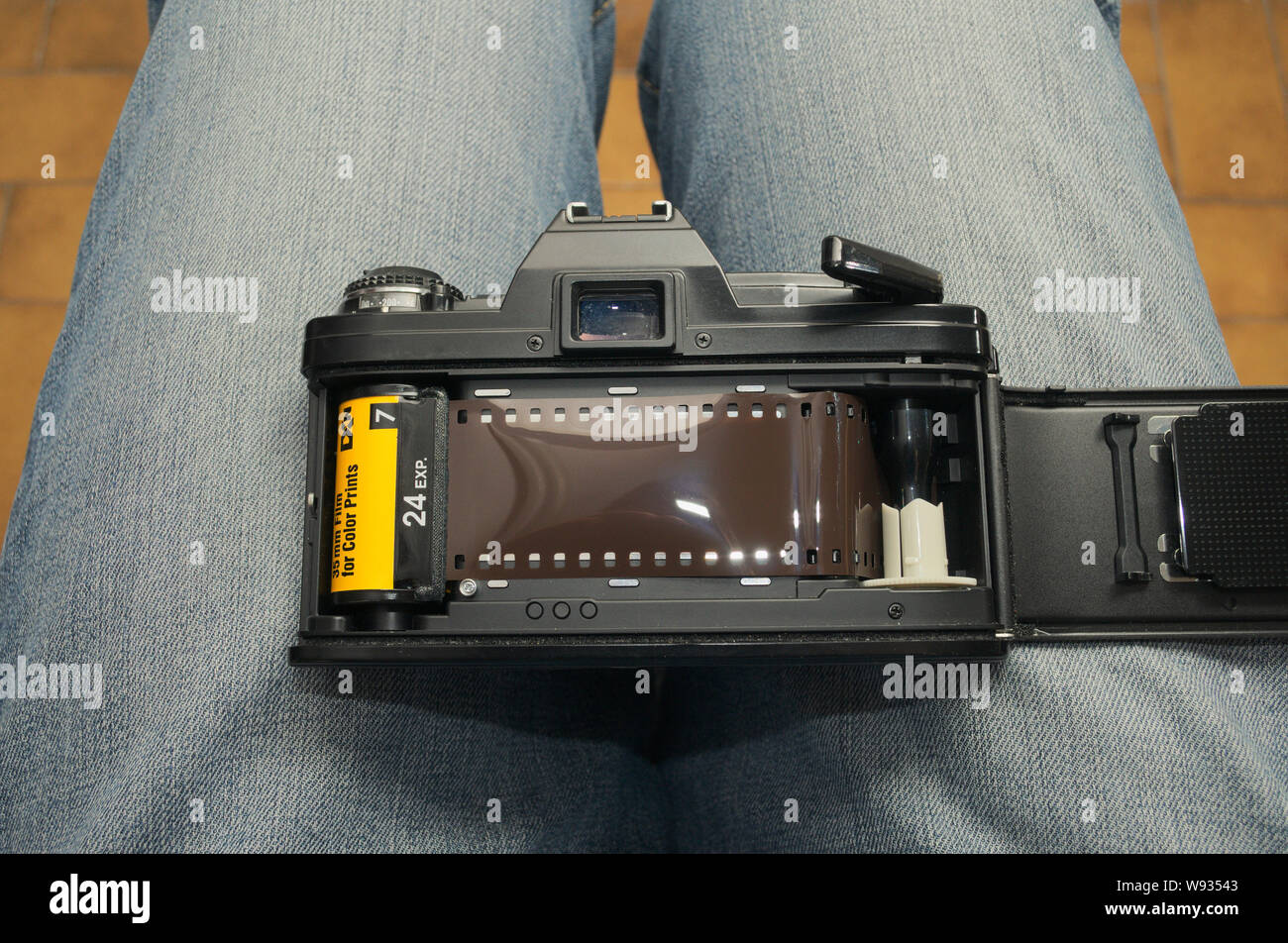 An SRL film camera loaded with a 35mm film held on legs Stock Photo